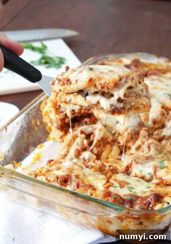 Triple Cheese Pasta Bake 3 scooping three cheese pasta out of dish