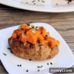 Buffalo Chicken Baked Potato with melted cheddar and green onions