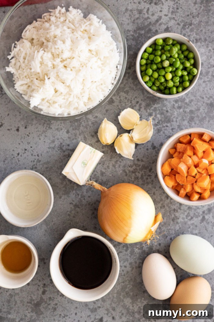 Rice, peas, carrots, garlic, butter, soy sauce, onion, egg, sesame oil are used to make fried rice.