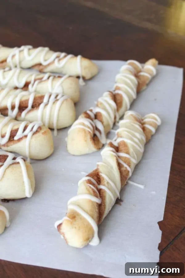 Homemade cinnamon twists, beautifully baked and drizzled with icing, ready to be served