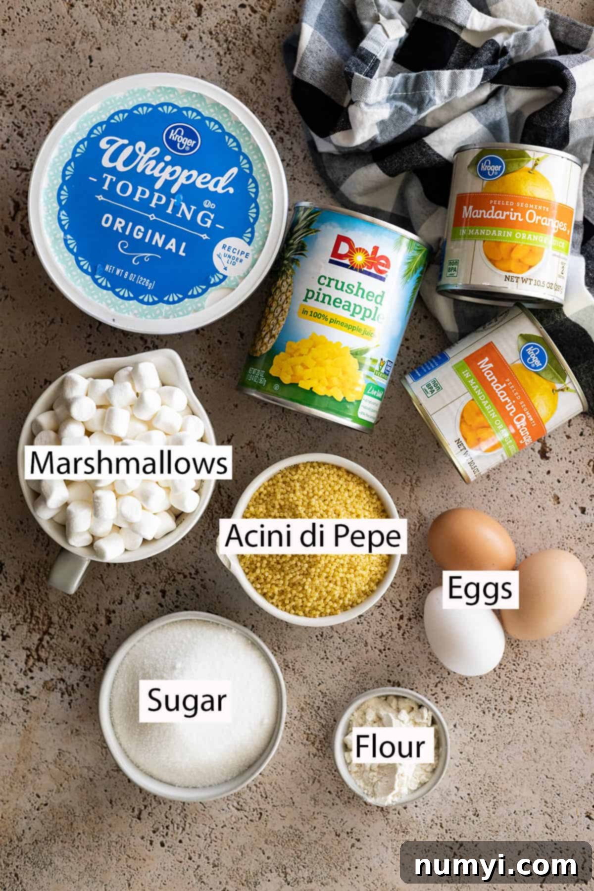 Golden Ambrosia Salad 3 Ingredients: whipped topping, crushed pineapple, mandarin oranges, miniature marshmallows, acini di pepe, eggs, sugar, flour.
