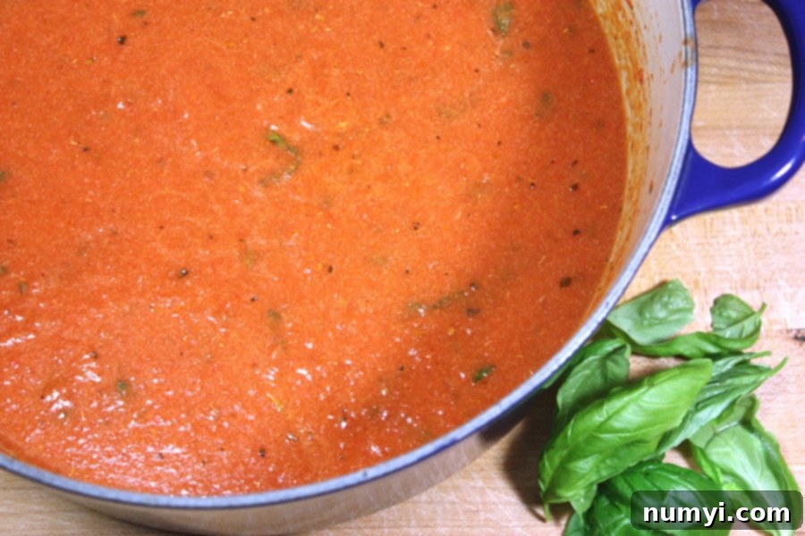 Effortless Creamy Tomato Basil Soup 4 Creamy tomato basil soup in a blue dutch oven.