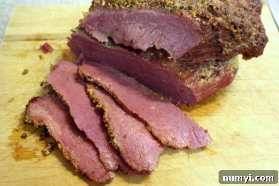 Corned Beef, sliced on a cutting board.