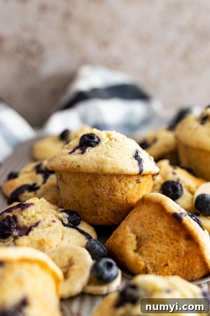 Blueberry banana muffins piled on top of each other.