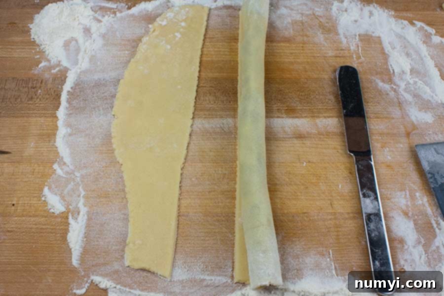 A rolled log of Cucidati dough with the seam side down, ready for slicing.