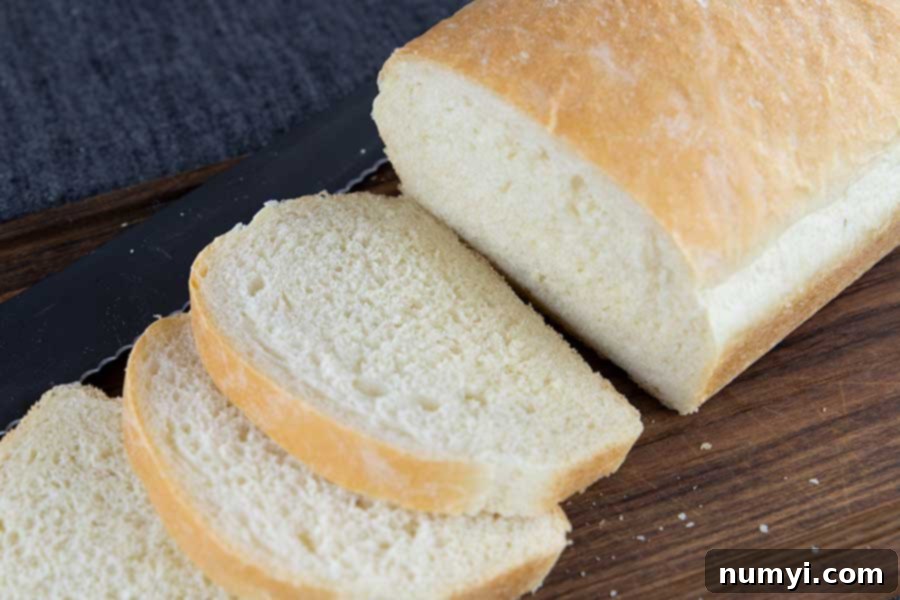 Beautifully sliced, homemade white bread, showcasing a consistent and light texture.
