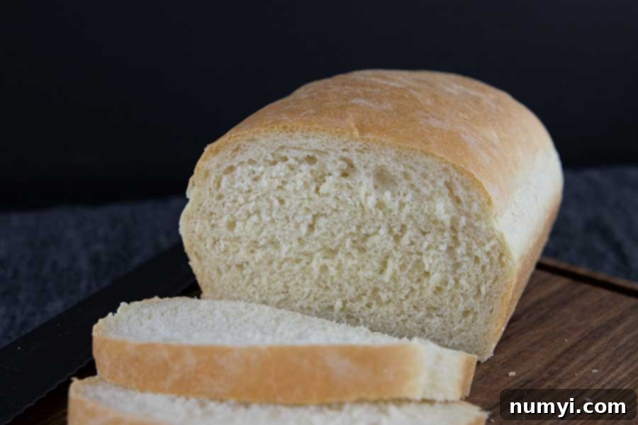 Freshly baked bread, perfectly sliced to reveal its soft, airy interior.