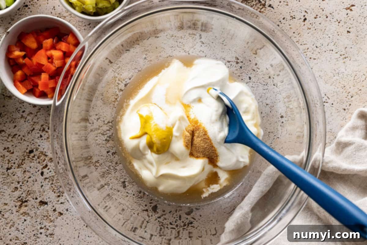 Mixing together the dressing ingredients.
