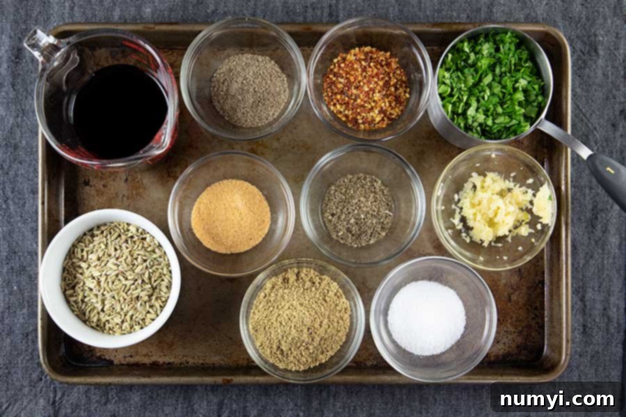 Authentic Homemade Fennel Italian Sausage Recipe 4 Prepared spices for Italian Sausage in small ramekins on a baking sheet, ready to be added to the meat.