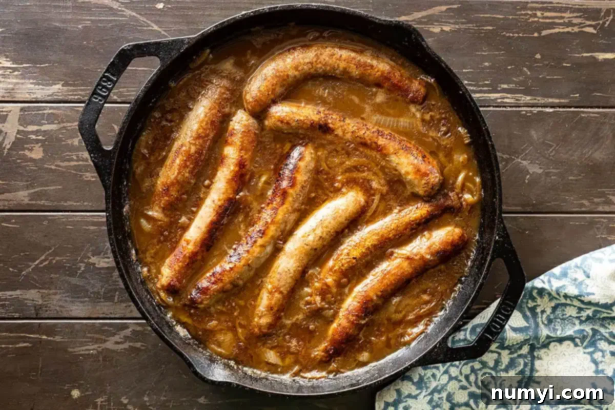 Sausages in onion gravy fresh from the oven and ready to eat. 