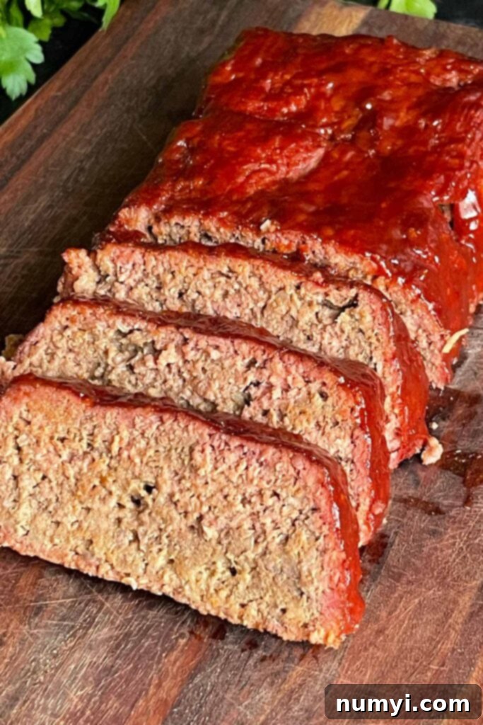 Smoky Meatloaf Perfection 11 Smoked meatloaf on a cutting board, perfectly sliced and ready to be served.