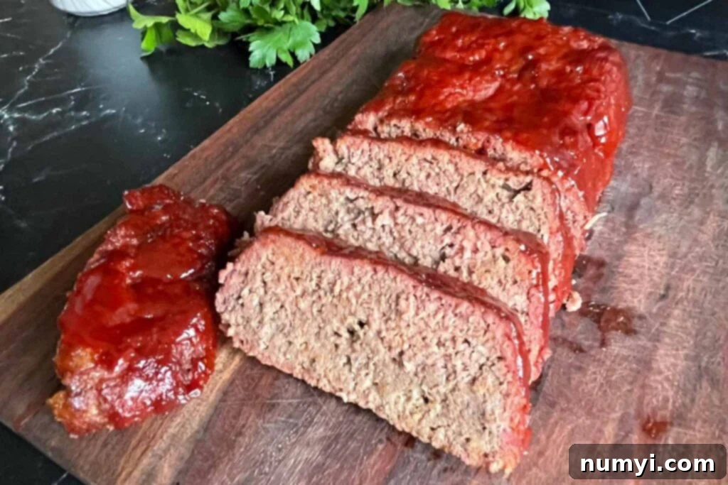 Smoky Meatloaf Perfection 3 Sliced smoked meatloaf on a cutting board, showcasing its juicy texture and smoke ring.