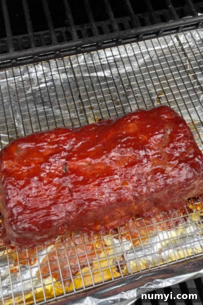 Smoky Meatloaf Perfection 10 Smoked meatloaf with a glistening glaze inside the smoker.