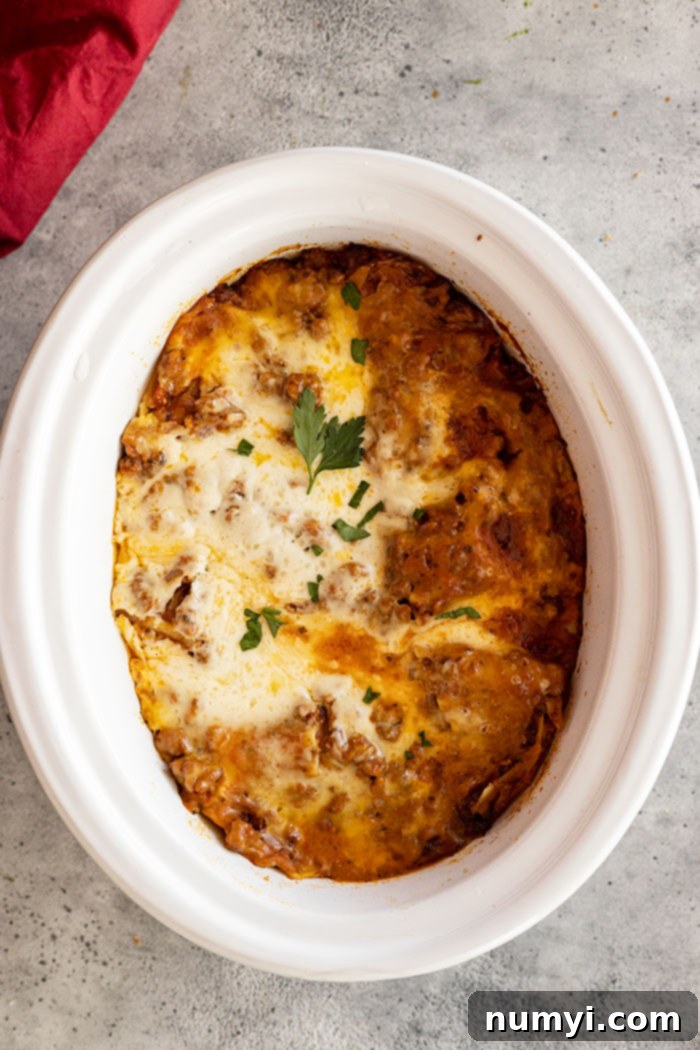 Overhead view of finished lasagna in the crockpot.