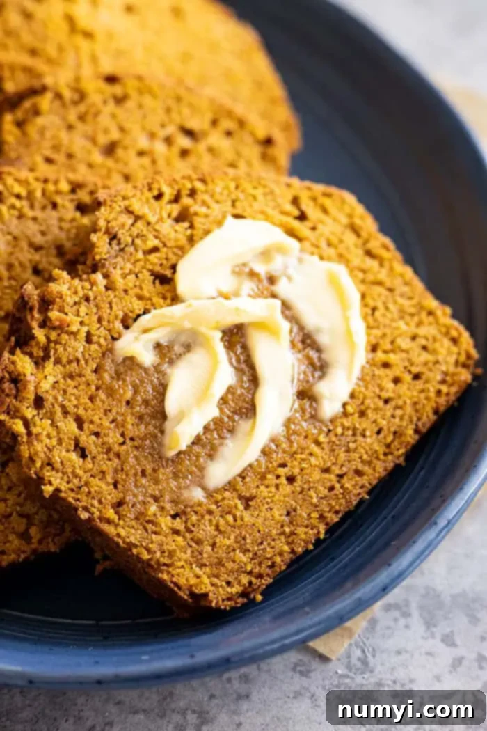 closeup: a slice of my simply pumpkin bread recipe with butter melting on it