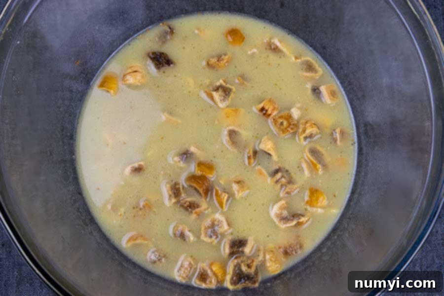 Chopped dried figs soaking in a warm mixture of water and butter, ready for the bread batter.