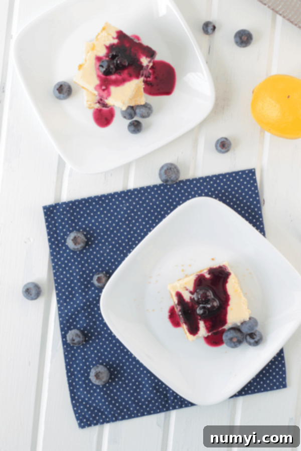 Zesty Lemon Cheesecake Bars 3 Lemon Cheesecake Bars on white plates with blueberry topping