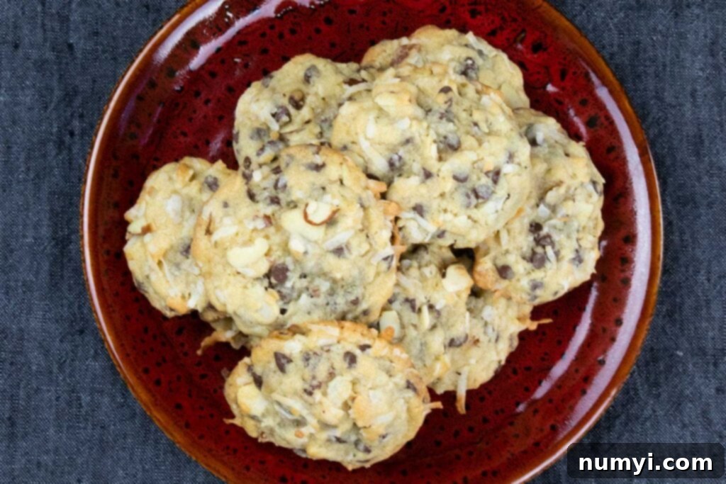 Freshly baked almond joy cookies presented on a vibrant red plate, ready to be enjoyed.