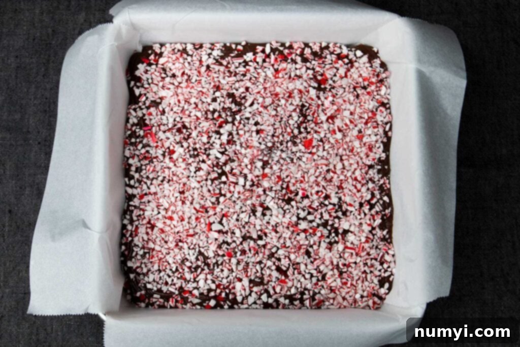 Peppermint fudge in a lined baking pan.