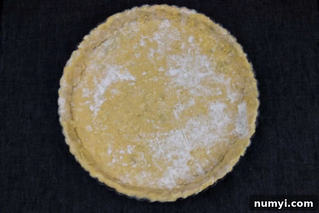 Tart dough expertly pressed into a tart pan, ready for chilling.