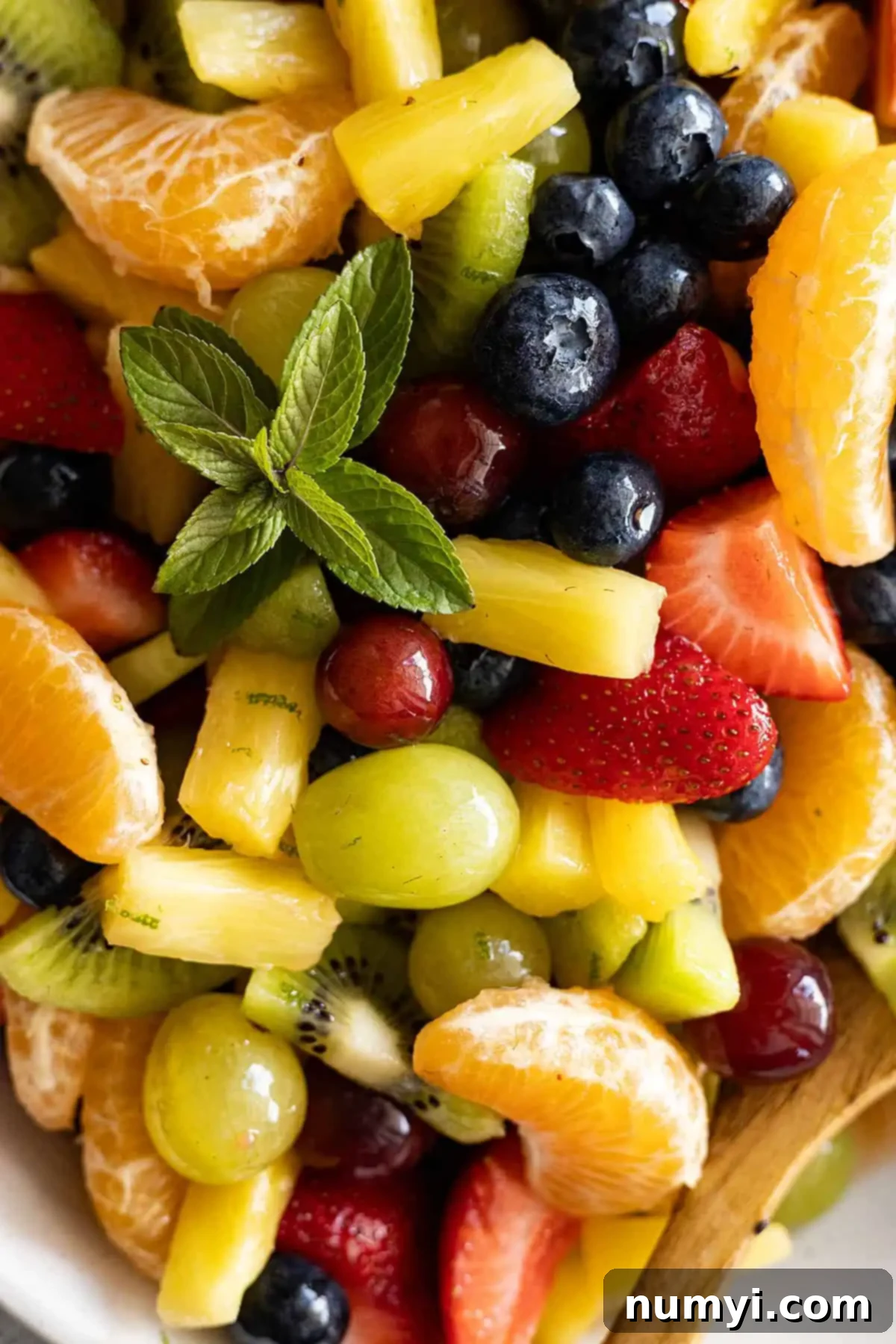 Close up of easy fruit salad. Fresh mint to garnish. 