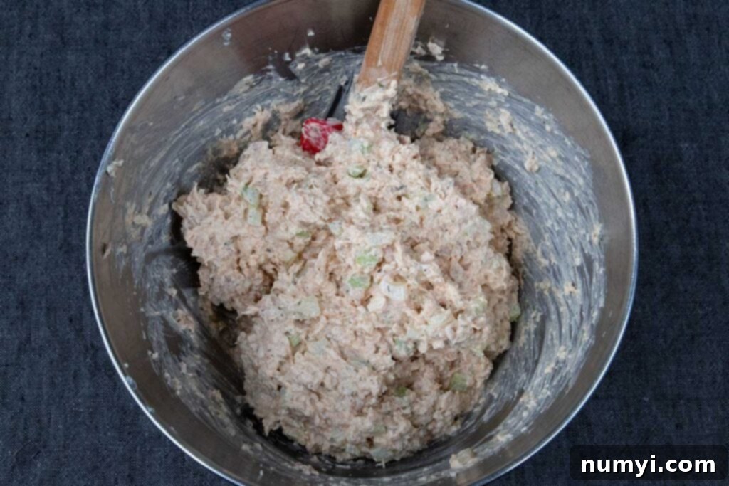 Signature Smoked Chicken Salad 6 Smoked chicken salad combined in a metal bowl.