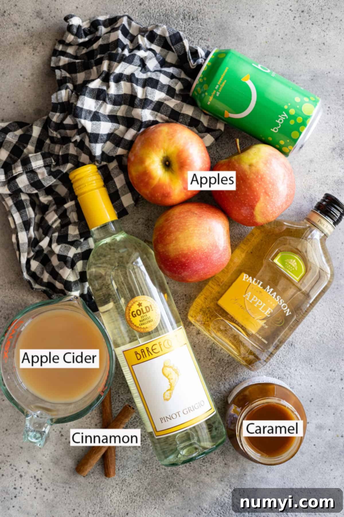 Ingredients: white wine, apple brandy, apple cider, caramel sauce, apples, sparkling water, cinnamon sticks.