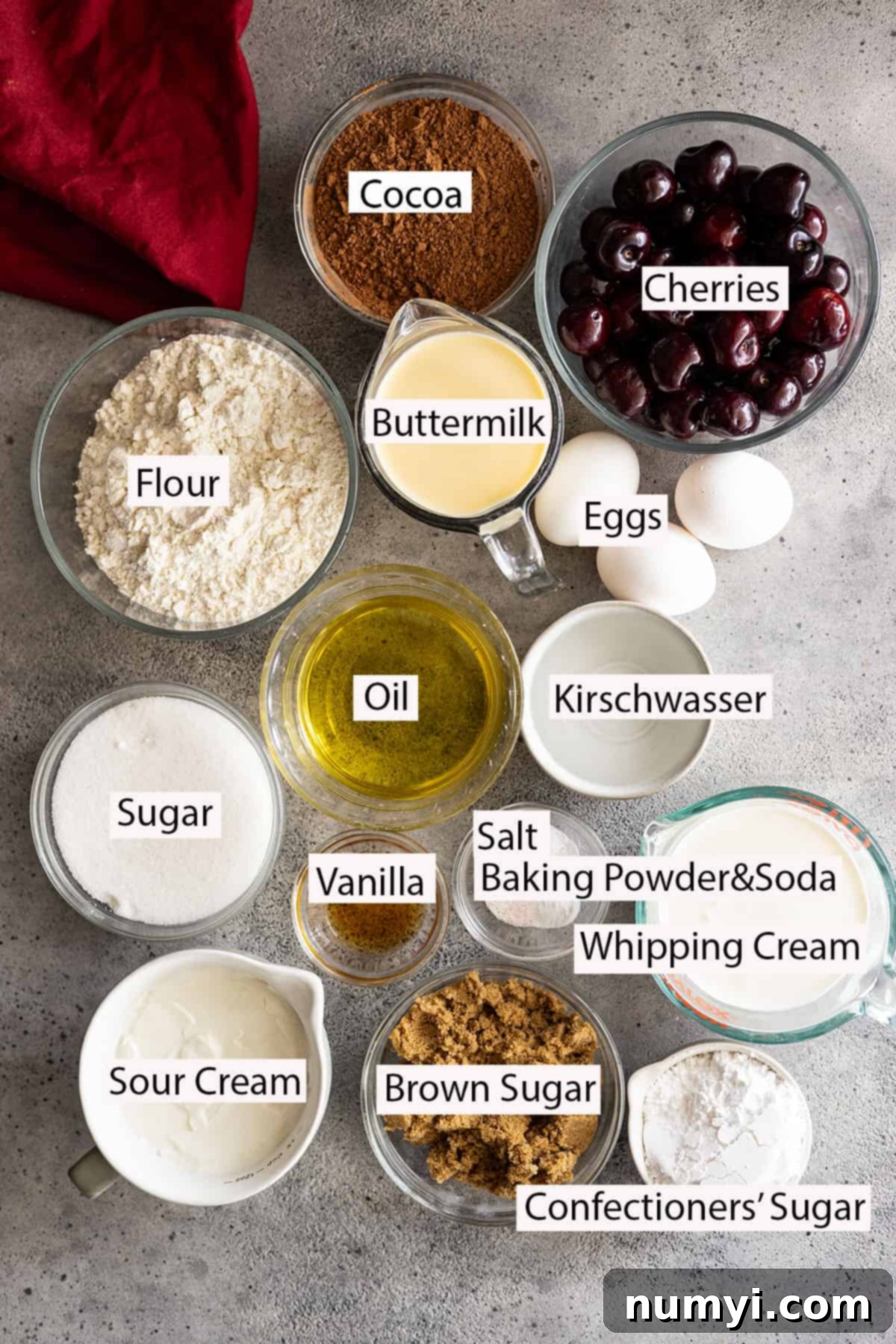 Ingredients: flour, cocoa, cherries, buttermilk, eggs, oil, sugars, vanilla, baking powder and soda, salt, kirschwasser, whipping cream, sour cream, confectioners sugar. 
