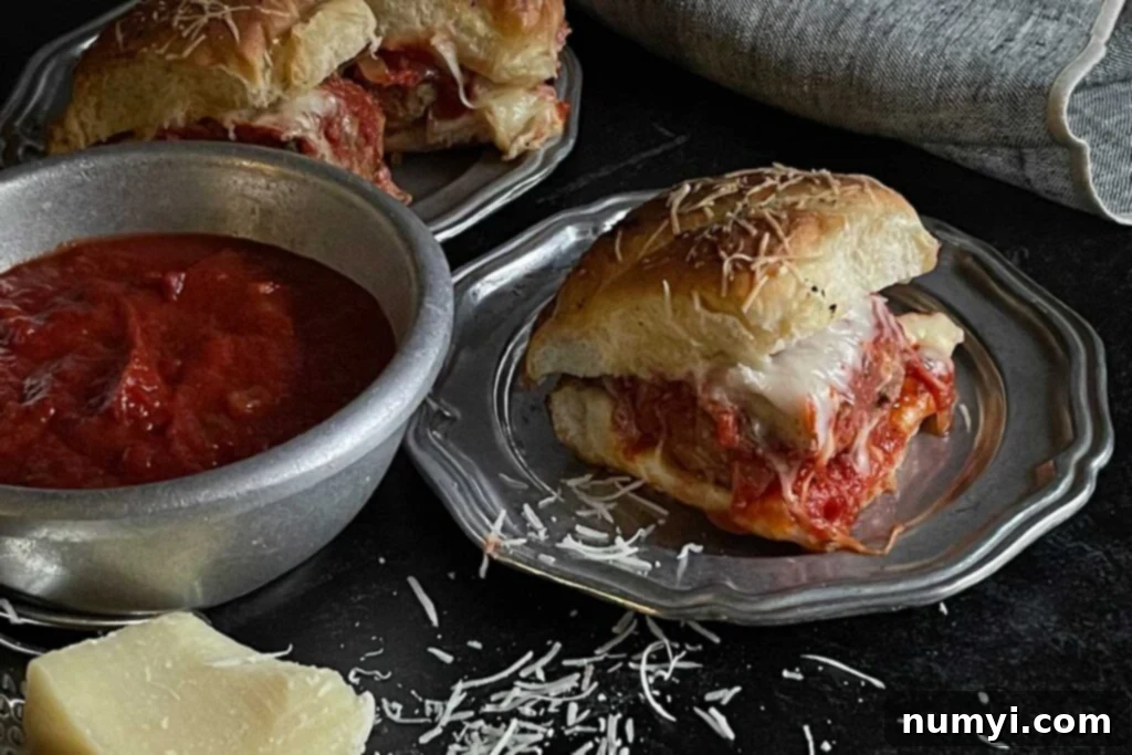 Meatball slider on a pewter plate.