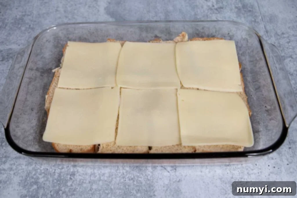 Cheese slices on top of the bottom buns.