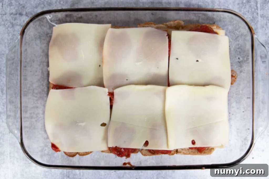 Cheese slices on top of the meatballs.