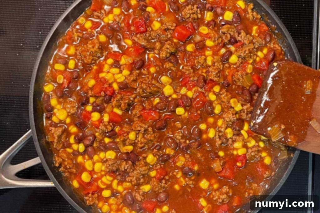 Frito pie mixture cooking on stovetop