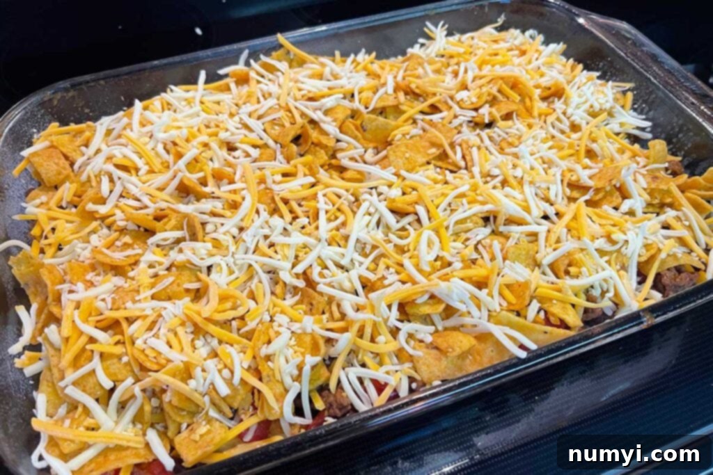 Frito pie casserole assembled and ready for baking