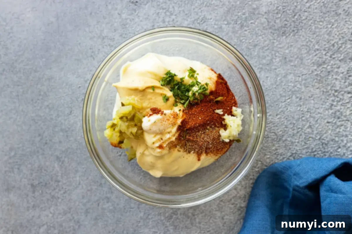 Overhead view of all the ingredients in a small bowl ready to be mixed. Blue napkin in the corner. 