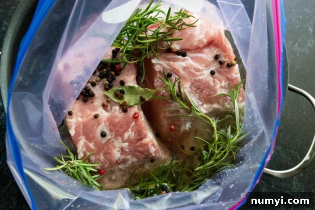 Smoked Porterhouse Pork Chops 5 Double bone-in pork chops soaking in a flavorful brine inside a large container.