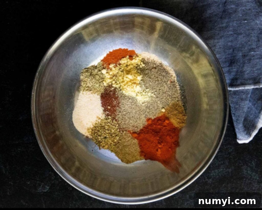 Smoked Porterhouse Pork Chops 6 A vibrant mix of various herbs and spices for the dry rub in a mixing bowl.