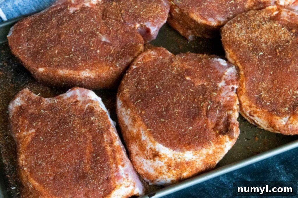 Smoked Porterhouse Pork Chops 7 Double bone-in pork chops liberally seasoned with a dry rub, ready for the smoker.