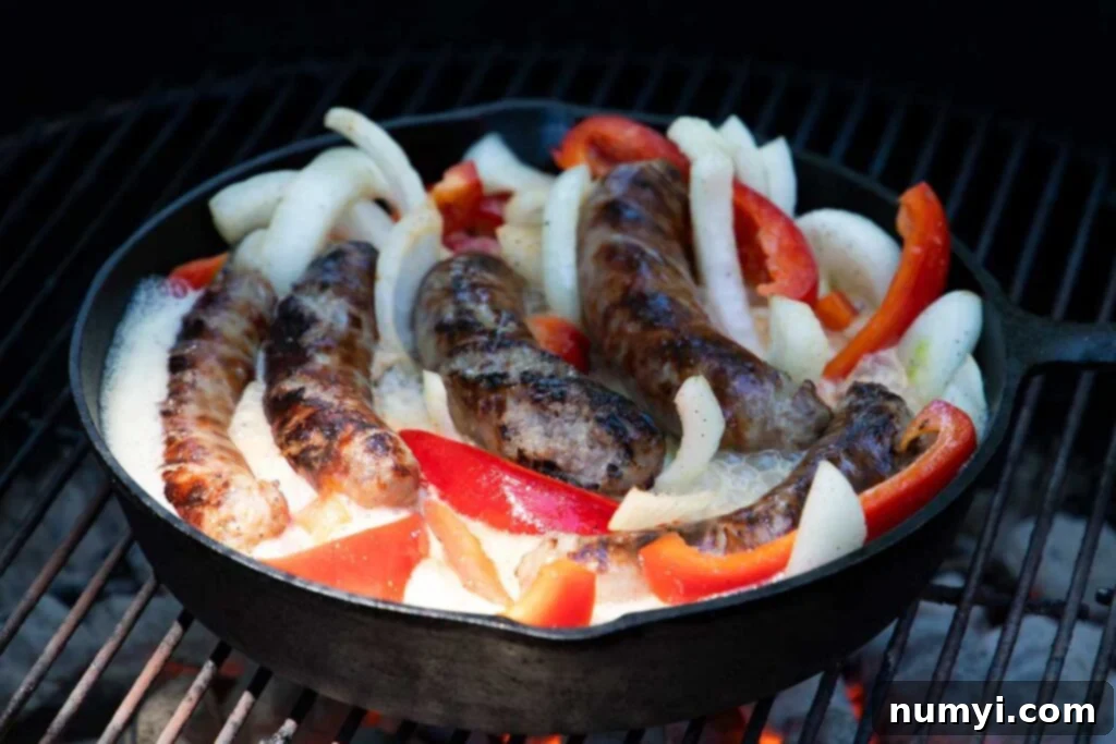 Sizzling Beer Brats with Peppers and Onions 5 Beer brats with onions and peppers on the grill