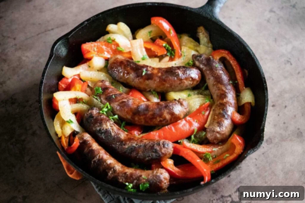 Sizzling Beer Brats with Peppers and Onions 6 beer brats with peppers and onions, cooked, in a cast iron skillet