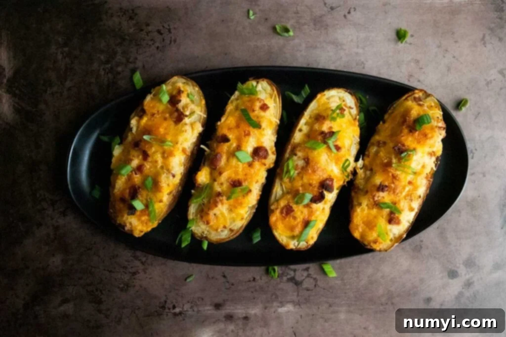 twice baked potatoes on a black serving dish