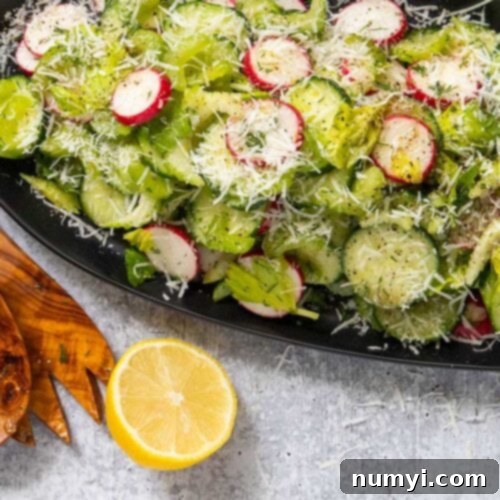 Cucumber radish salad on a black platter.