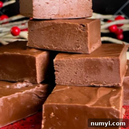 Extra dark chocolate fudge pieces stacked on a plate.
