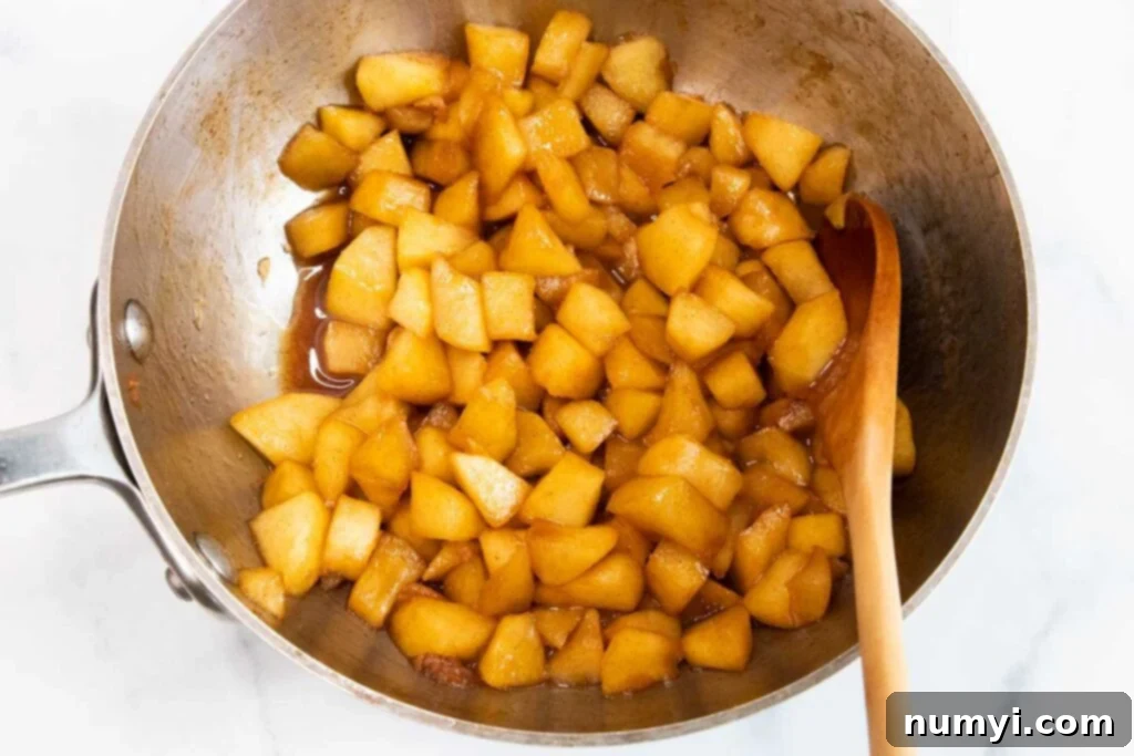 Quick & Flaky Apple Hand Pies 4 Chopped apples cooked in a saucepan.
