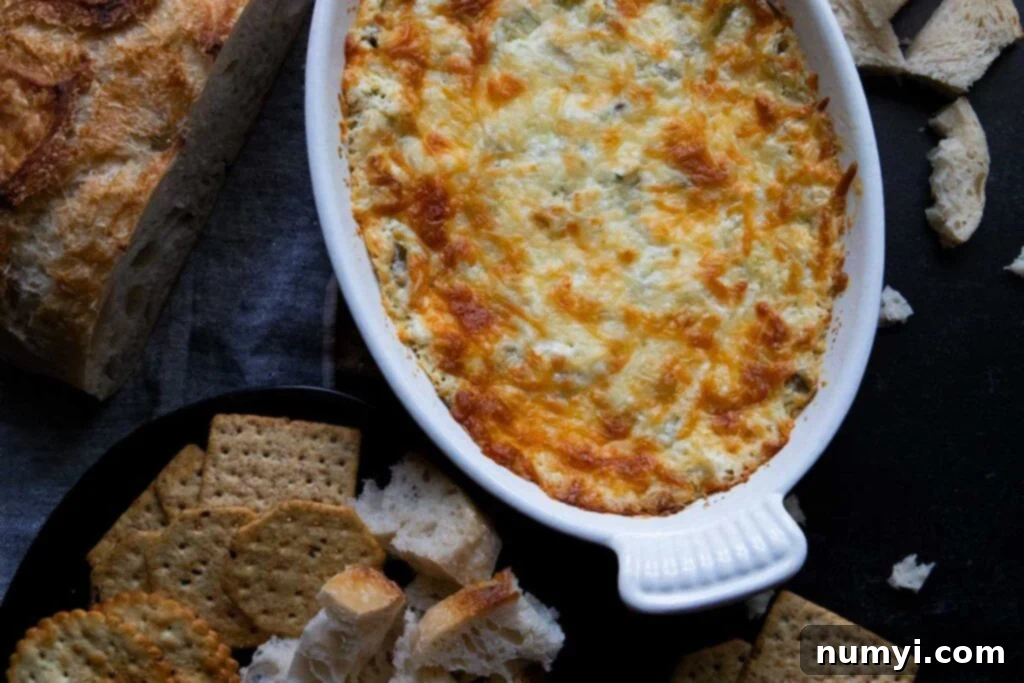 Artichoke dip in a white baking pan.