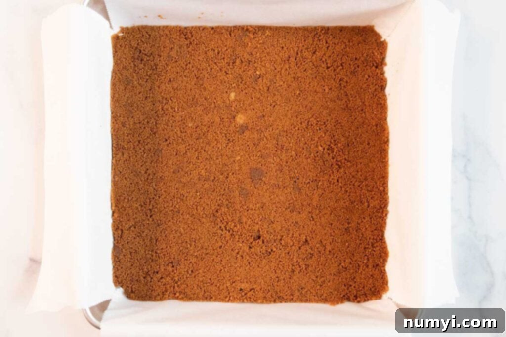 Velvety Pumpkin Spice Bars 4 A pre-baked gingersnap cookie crust, golden brown and perfectly pressed into an 8x8 baking pan lined with parchment paper.
