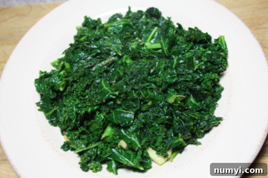 Freshly prepared Sautéed Kale in a large skillet, ready to be served. A perfect side dish for any meal, promising a delightful flavor that will win over even kale skeptics.