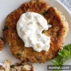 Overhead view of tartar sauce on a tuna patty.