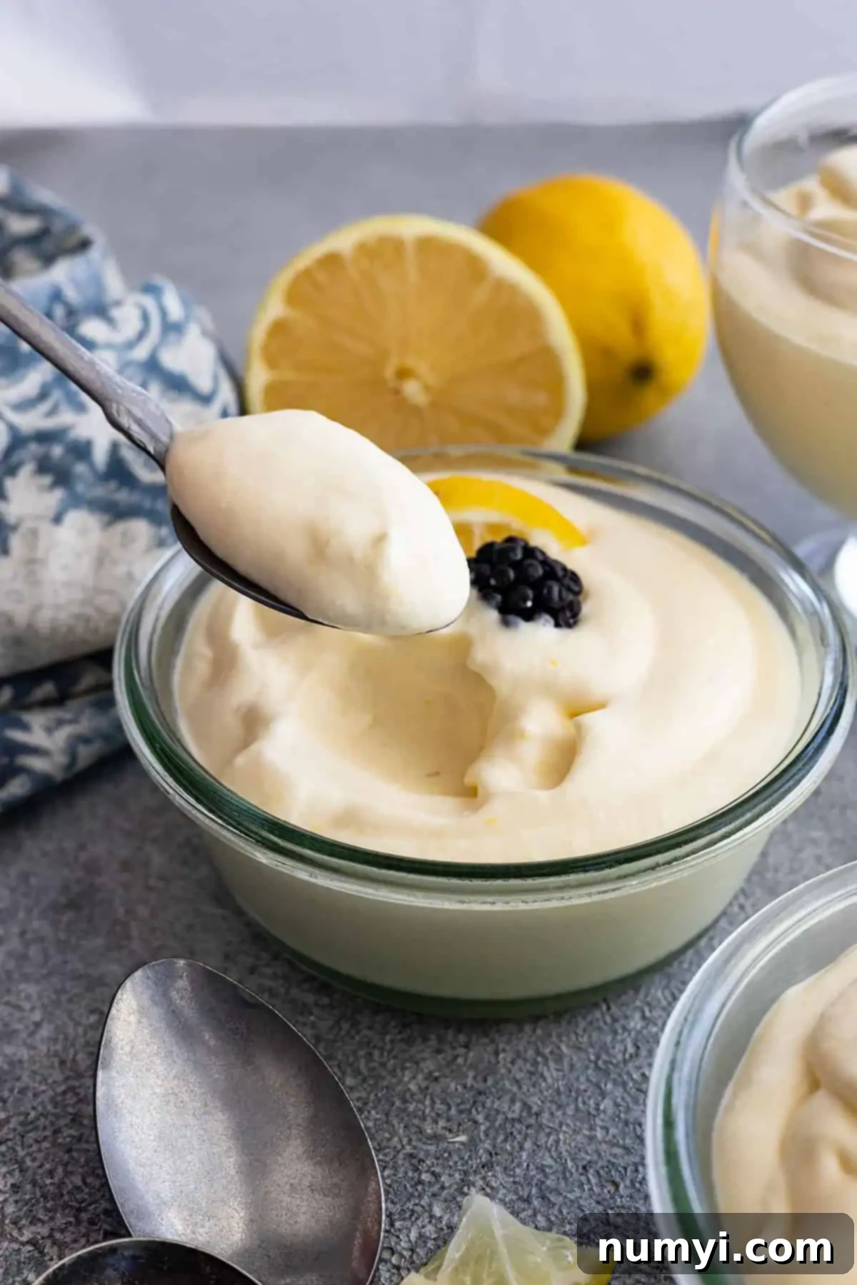 A spoon taking a spoonful of lemon mousse to show how light and fluffy it is. 