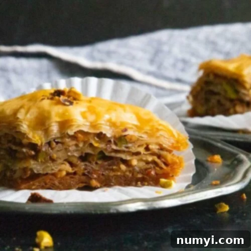 Baklava slices on sliver plates.