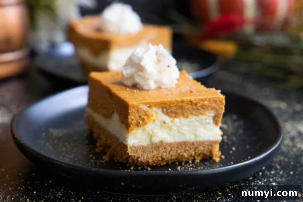 A perfectly sliced pumpkin cheesecake bar, showcasing its distinct layers, rests elegantly on a black plate, ready to be enjoyed.